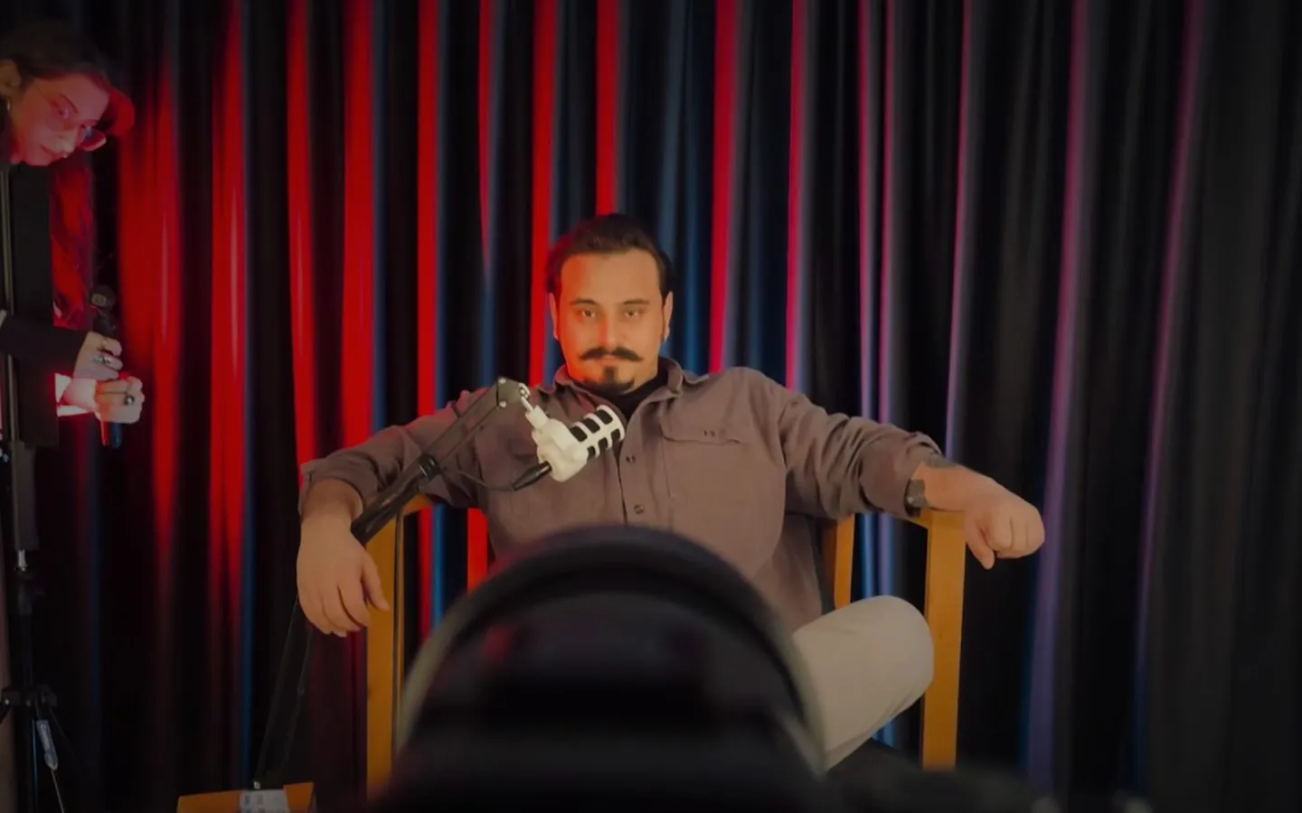 Reklamartgo studio production: Doğan Özhan on set in front of a red-lit curtain
